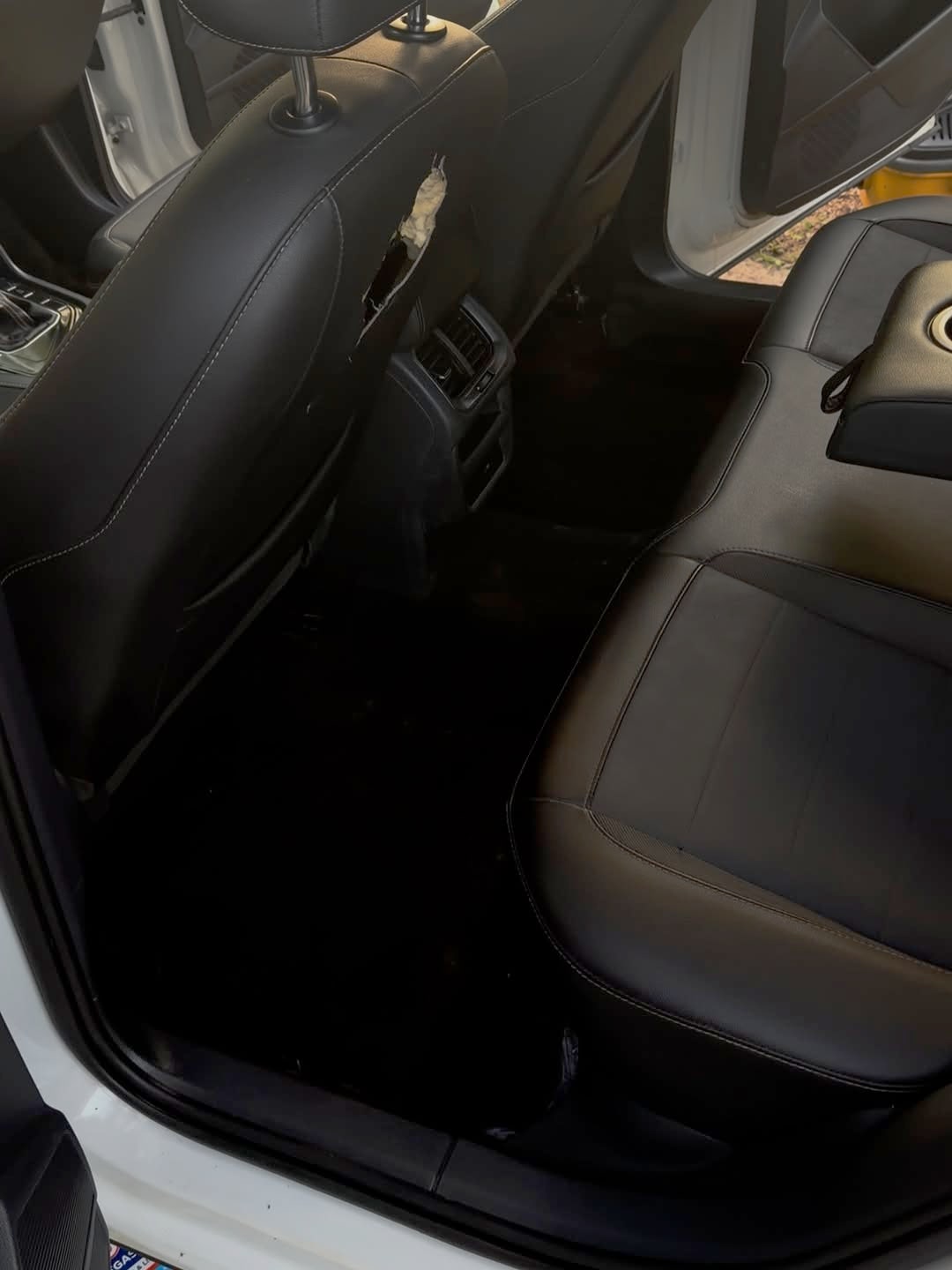After detailing by MaddStripez Detailing — Back seat & floor — caked-in dirt and debris deep-cleaned out